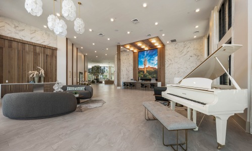 white piano and expansive digital art wall